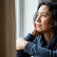 A person by a window reflecting quietly, showing the calm side of living with mood disorders